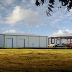 White steel building and red steel framing under construction