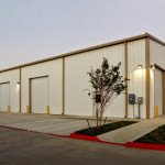 Steel building with garage doors and parking