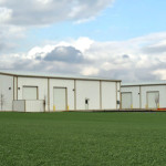 Two white industrial steel buildings