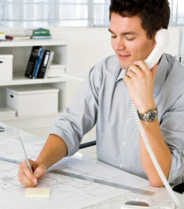 photo of a metal building sales man on the phone with a customer.