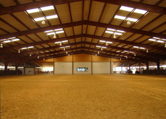 photo of the interior of a steel horseback riding arena