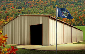 Attractive tan and brown metal building against an autumn forest background