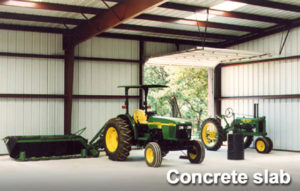 Photo of a metal barn with a slab floor.