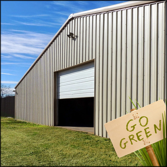 A large ivory-colored metal building with a sign in front that reads "Go Green"
