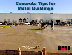 Man smoothing the concrete foundation at a RHINO Steel Building construction site