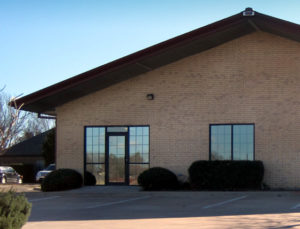 Photo of a RHINO brick-covered building with fixed glass windows.