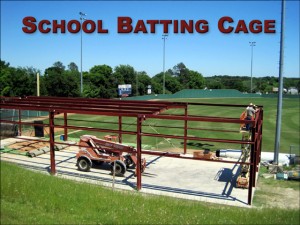 Photo of a steel building batting cage under construction at a high school