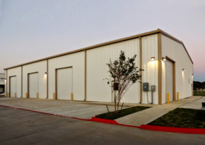 Photo of a RHINO metal building at twilight.