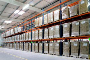 Photo of the interior of a large steel warehouse.