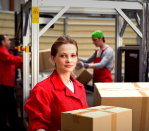 Photo of workers in a prefab metal building manufacturing plant.