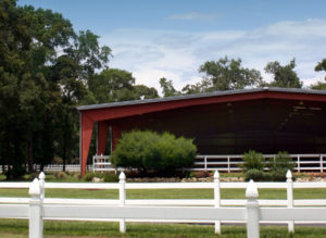 Photo of a large steel covered riding arena.