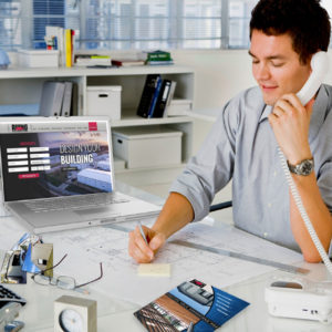 Photo of a man ordering a RHINO metal building by phone.