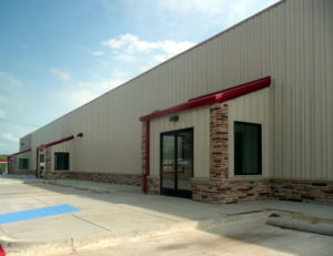 Photo of a tan RHINO commercial building with rock trim.