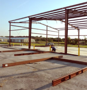 Photo of a man erecting a RHINO metal building kit.