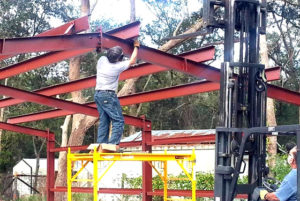 Photo of a man and his father erecting their own RHINO metal building.