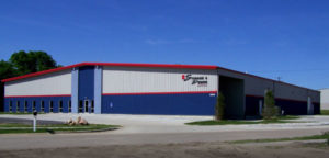 Photo of a massive red, white, and blue prefab steel building.