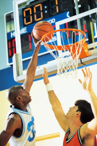Photo of basketball players in a gym.